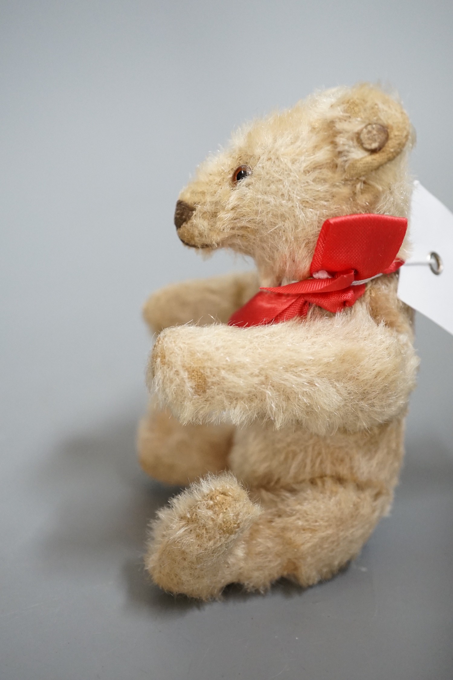 A small Steiff bear, with button in ear, c.1920, 14cm high